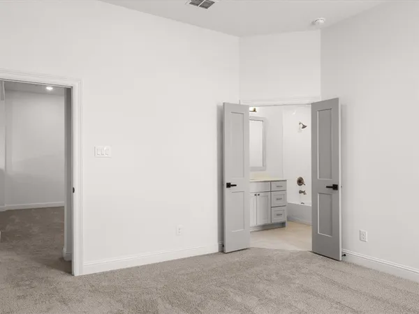 an empty room with a cabinet and a toilet