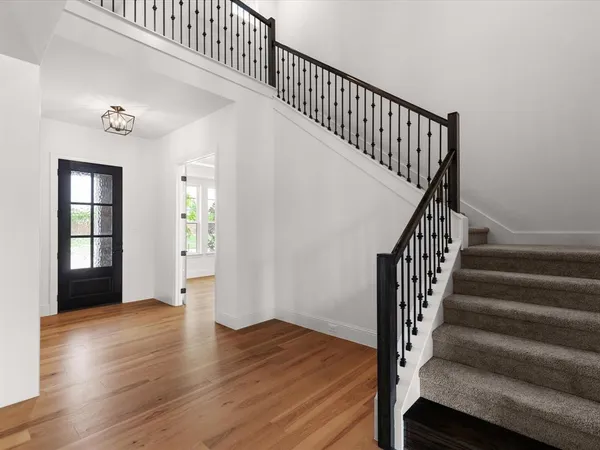 a view of an entryway with wooden floor and door
