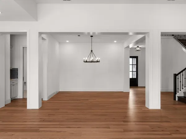 a view of a room with wooden floor and staircase