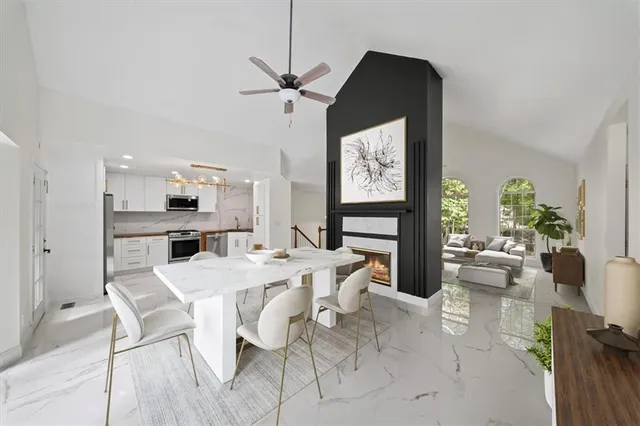 a kitchen with white cabinets and appliances