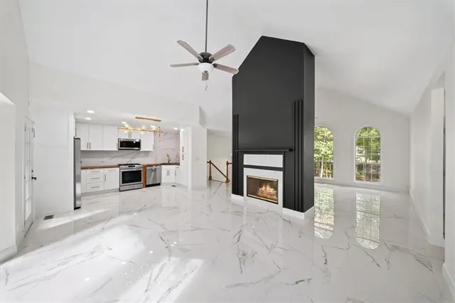 a bathroom with a double vanity sink a mirror and bathtub