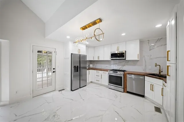 a view of walk in closet with clothes