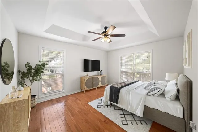 a spacious bedroom with a bed and a potted plant