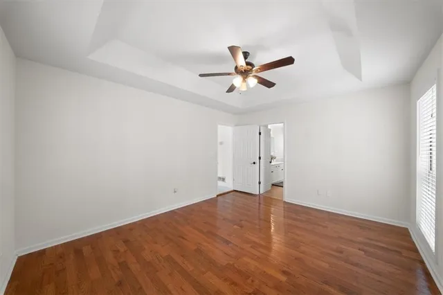 a bathroom with a sink a toilet a mirror a vanity and shower