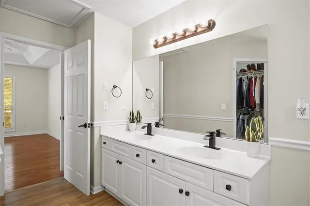 a view of bathroom with a toilet sink and mirror