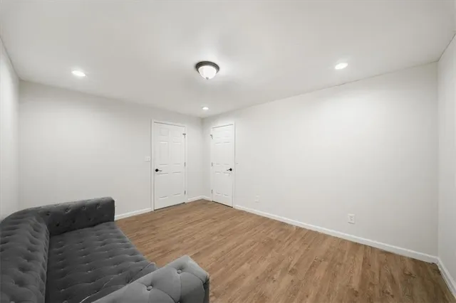 a view of swimming pool with lawn chairs and plants