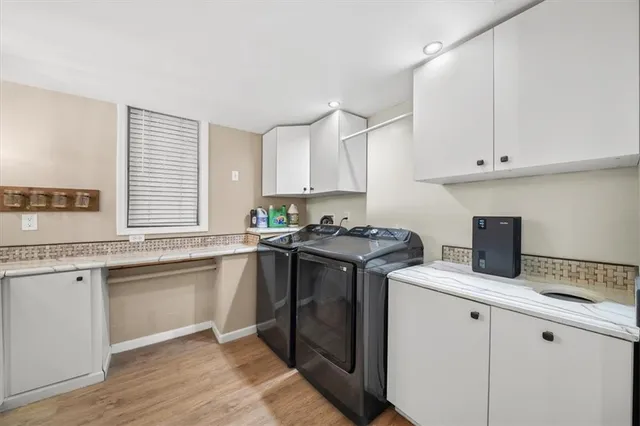 a view of backyard with wooden fence and large trees