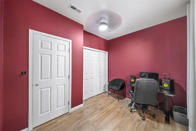 a living room with stainless steel appliances furniture and a flat screen tv