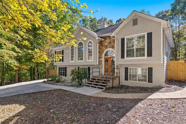 a view of staircase with lots of frames on wall and a window