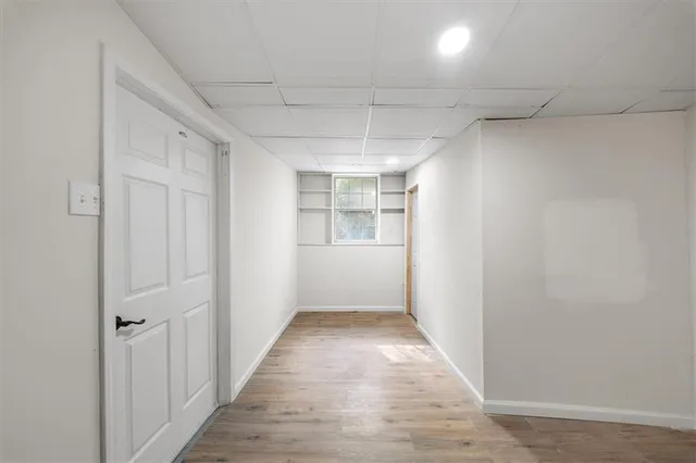 a living room with furniture a flat screen tv and a large window