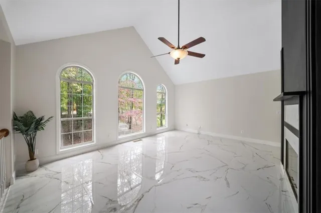 a living room with furniture and a dining table with kitchen view