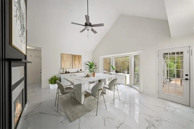 a living room with furniture a chandelier and a large window