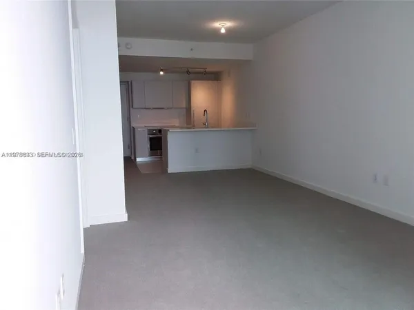 a bedroom with a bed and painting on the wall