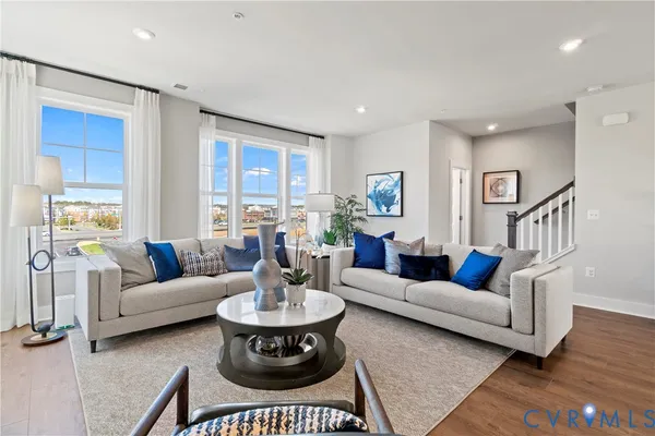 a living room with furniture kitchen view and a fireplace