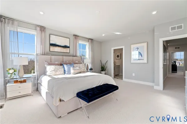 a bedroom with a bed a couch and dresser