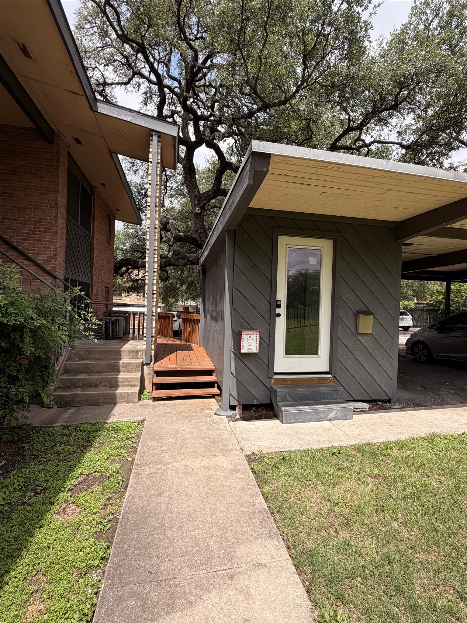 3304 Red River Street, Unit 203 Austin, TX 78705 - Photo 13 of 16 a front view of a house with a yard