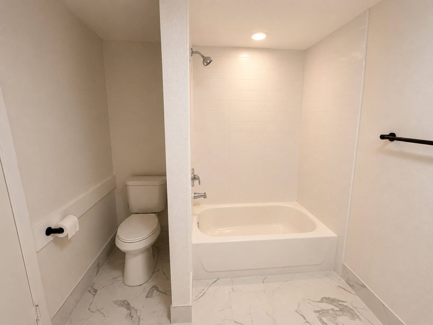 3304 Red River Street, Unit 203 Austin, TX 78705 - Photo 9 of 16 a bathroom with a toilet and a bathtub