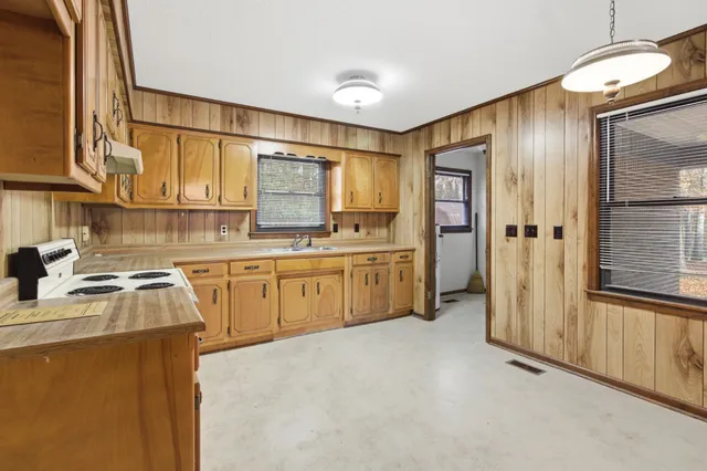 a kitchen with white cabinets and white appliances