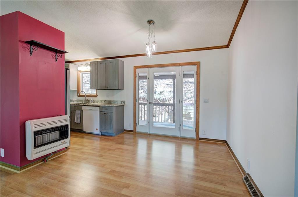 147 Laurel Mill Trail Jasper, GA 30143 - Photo 12 of 64 a kitchen with stainless steel appliances granite countertop a stove a sink dishwasher a microwave oven and a dining table with wooden floor