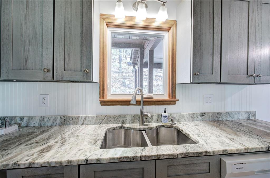 147 Laurel Mill Trail Jasper, GA 30143 - Photo 17 of 64 a kitchen with granite countertop a sink and a stove