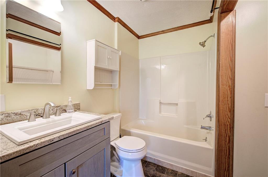 147 Laurel Mill Trail Jasper, GA 30143 - Photo 26 of 64 a bathroom with a sink a toilet and shower