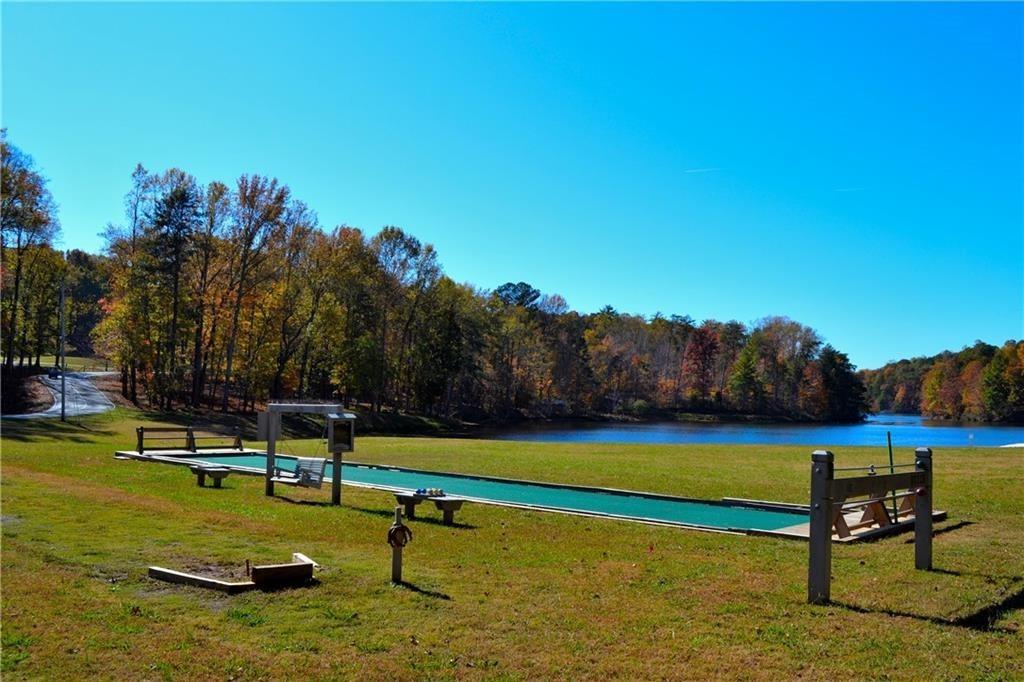 147 Laurel Mill Trail Jasper, GA 30143 - Photo 51 of 64 a view of a swimming pool with a bench and trees in the background