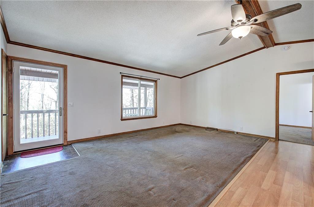 147 Laurel Mill Trail Jasper, GA 30143 - Photo 6 of 64 an empty room with windows and fan