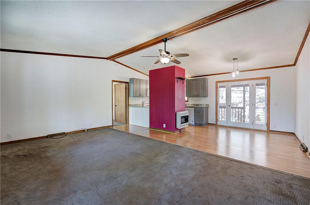 147 Laurel Mill Trail Jasper, GA 30143 - Photo 8 of 64 en empty room with windows and ceiling fan