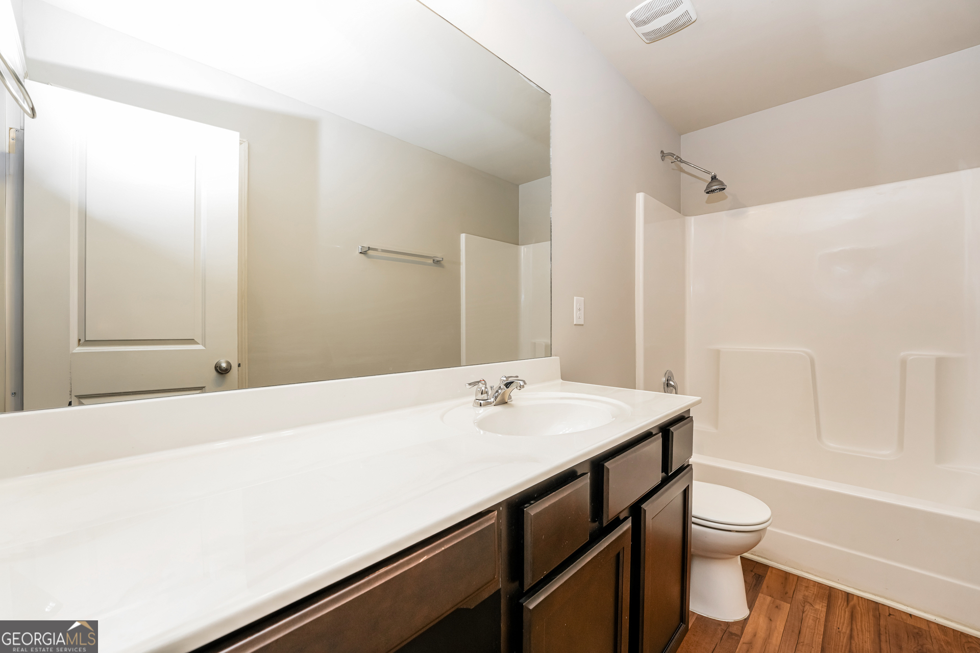 830 Castilla Way Winder, GA 30680 - Photo 13 of 23 a bathroom with a sink a toilet and a large mirror