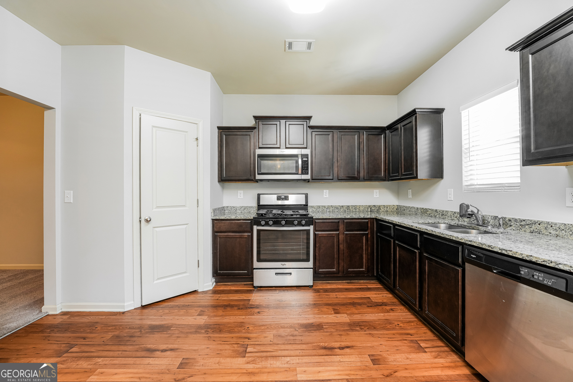 830 Castilla Way Winder, GA 30680 - Photo 6 of 23 a kitchen with stainless steel appliances granite countertop a stove cabinets and a refrigerator