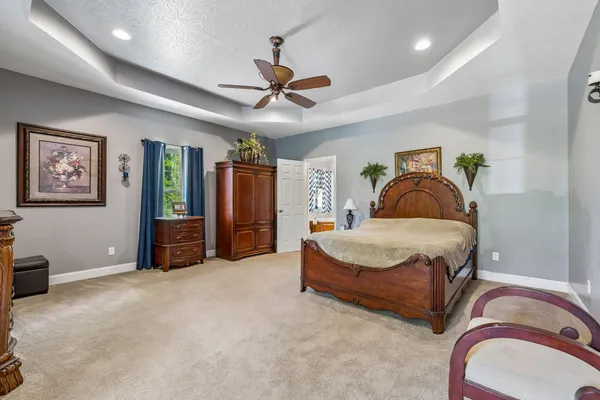 a bedroom with a bed and ceiling fan