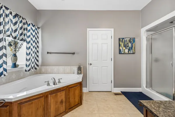 a bathroom with a tub sink and a mirror