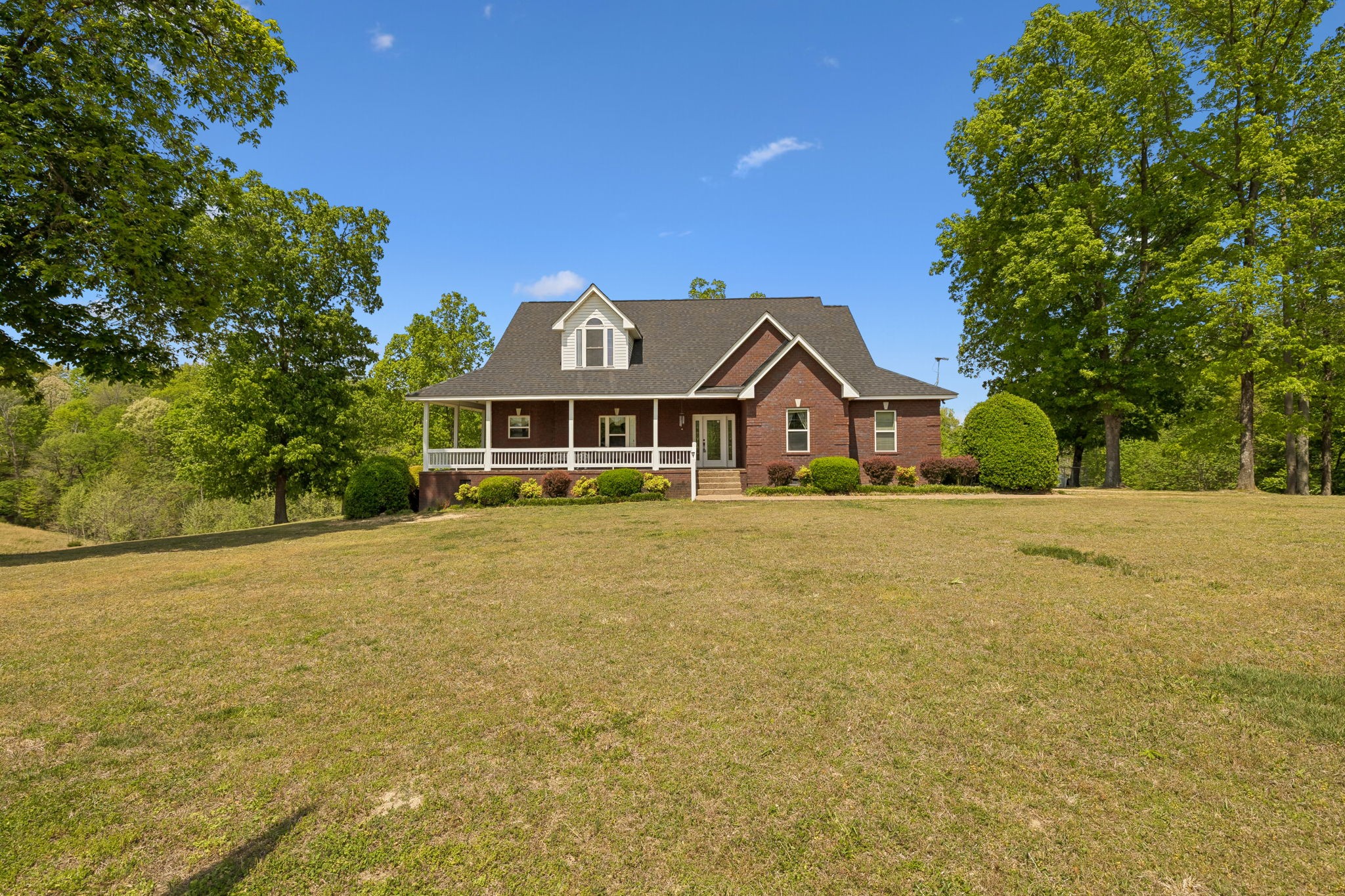 1709 Holland Road Lafayette, TN 37083 - Photo 2 of 44 a front view of a house with a yard and garage