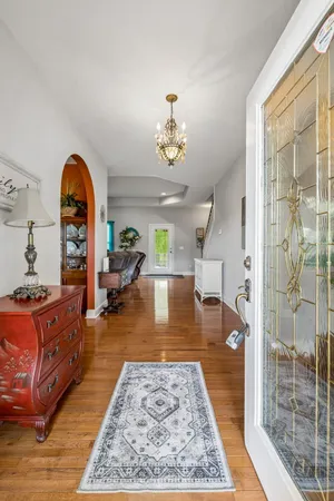 a living room with furniture and a chandelier