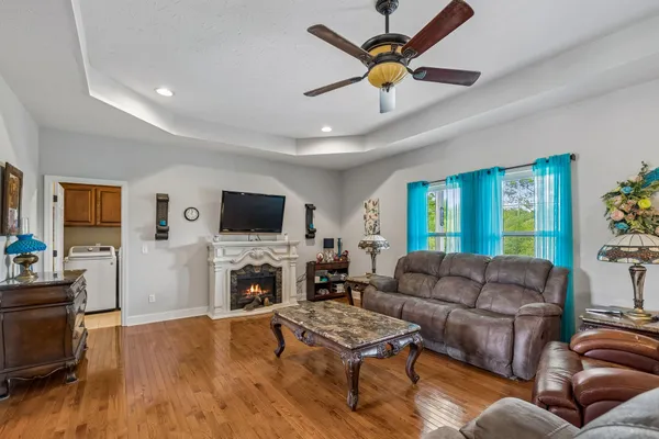 a living room with furniture a flat screen tv and a fireplace