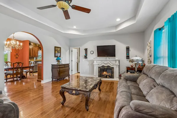 a living room with furniture a fireplace and a flat screen tv