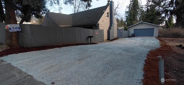 6221 South 129th Street Seattle, WA 98178 - Photo 1 of 20 a front view of a house with a yard and garage