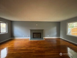 6221 South 129th Street Seattle, WA 98178 - Photo 2 of 20 a view of an empty room with window and wooden floor
