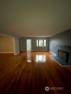 6221 South 129th Street Seattle, WA 98178 - Photo 4 of 20 a view of empty room with wooden floor and fan