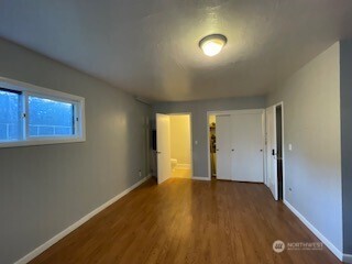 6221 South 129th Street Seattle, WA 98178 - Photo 7 of 20 an empty room with wooden floor and windows