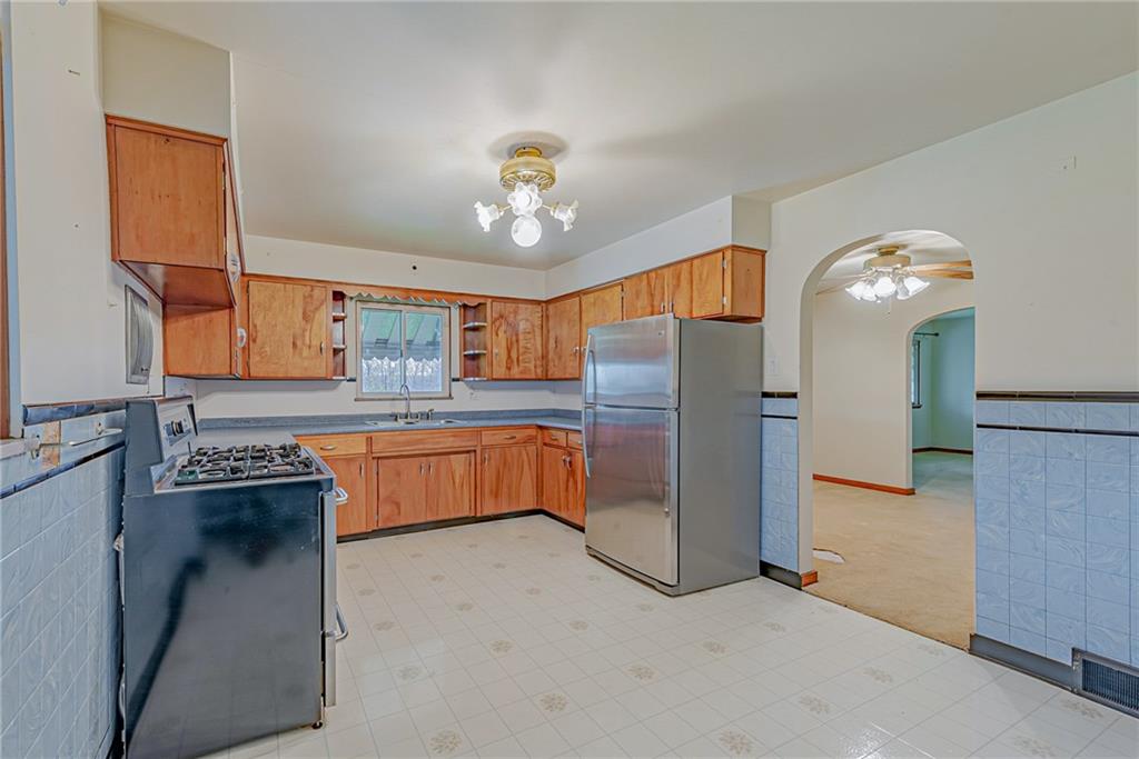 735 Highway 56 Apollo, PA 15613 - Photo 6 of 20 a kitchen with refrigerator and cabinets
