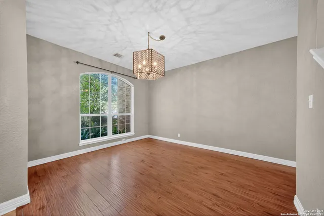 a view of wooden floor and windows in a room