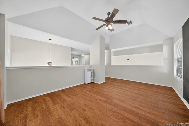 a view of a kitchen with wooden floor and a sink