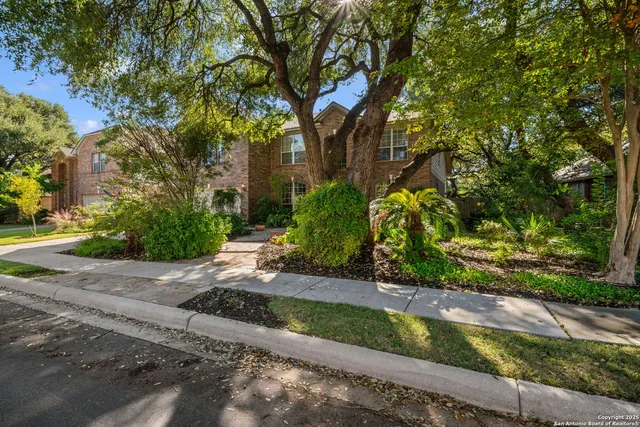 a pathway of a house with a yard