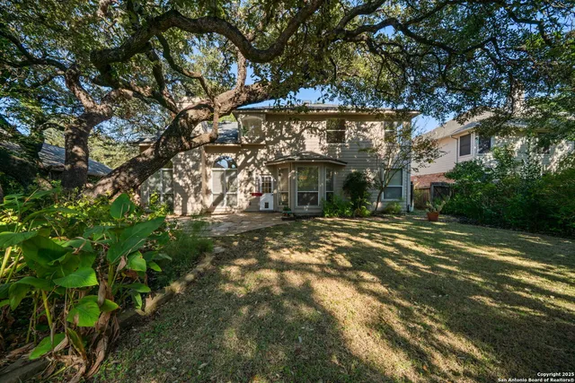 a view of a house with a tree