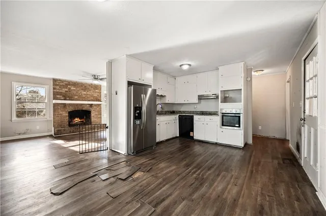 a kitchen with stainless steel appliances a refrigerator and a stove top oven