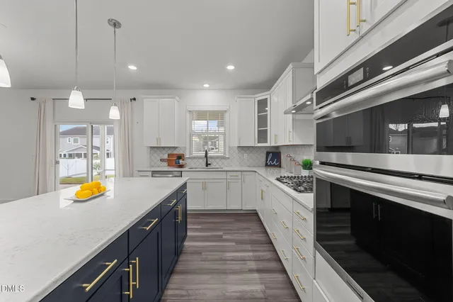 a kitchen with a sink stainless steel appliances and cabinets