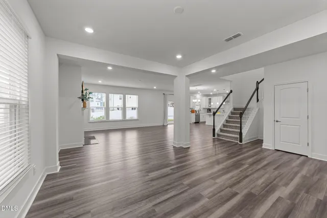 a view of an entryway with wooden floors and stairs