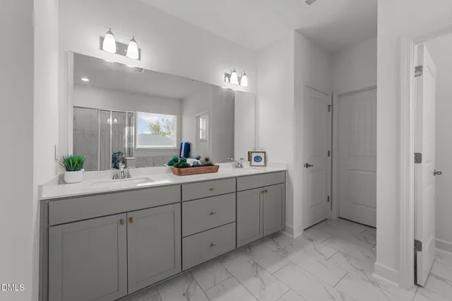 a bathroom with a double vanity sink and a mirror