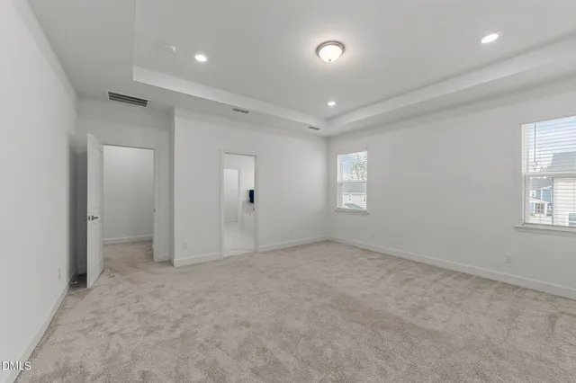 an empty room with windows and closet